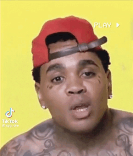 Man in Red Hat With Face Tattoo Making Funny Face