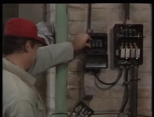 Man in Red Hat Working on Electrical Box