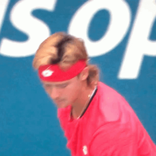 Man in Red Headband and Red Shirt in Front of Son Sign