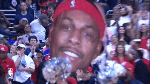Man in Red Headband Holding Diamond in Front of Crowd