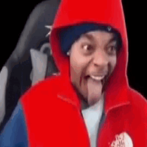 Man in Red Hoodie and Red Vest Sticking Tongue Out