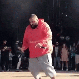 Man in Red Hoodie Dancing in Front of Crowd
