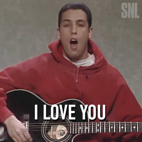 Man in Red Hoodie Playing Guitar and Singing