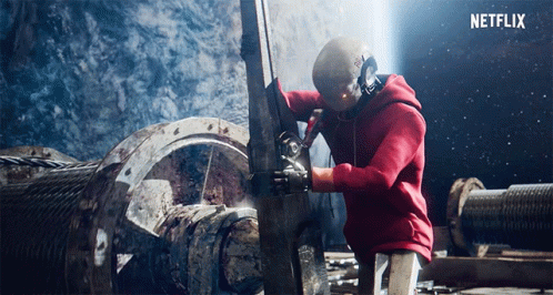 Man In Red Hoodie Working On Machine GIF