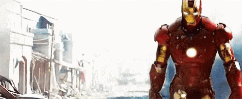 Man in Red Iron Man Suit Standing in Front of Building