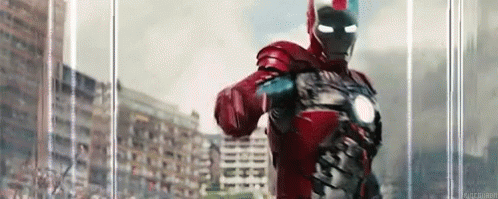 Man in Red Iron Man Suit Standing in Front of Building