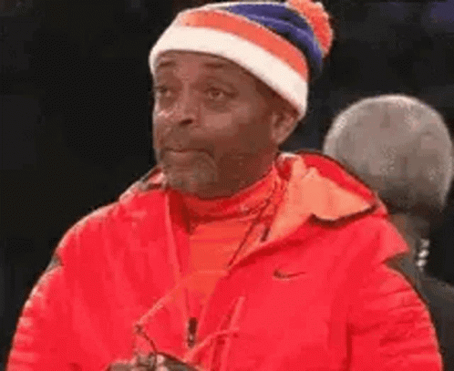Man in Red Jacket and Blue-White Hat Looking