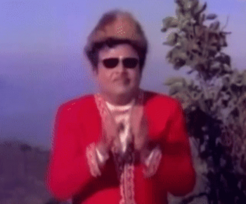 Man in Red Jacket and Hat Clapping Hands