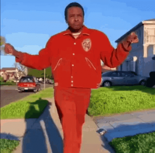 Man in Red Jacket and Pants Walking
