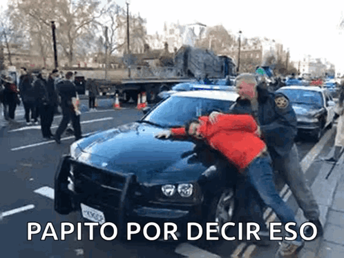 Man In Red Jacket Arrested By Police Officer In Front Of Car GIF