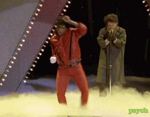 Man in Red Jacket Dancing and Man Singing