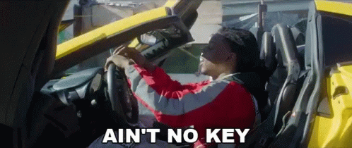 Man in Red Jacket Driving Yellow Car