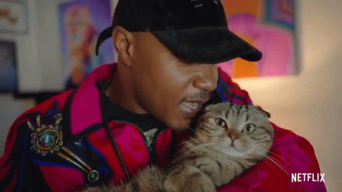 Man in Red Jacket Holding Cat