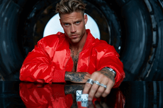 Man in Red Jacket Holding Dice