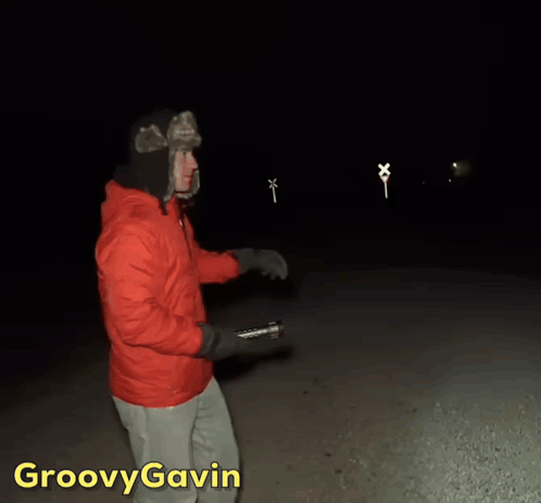 Man in Red Jacket Holding Flashlight Groovy Gavin