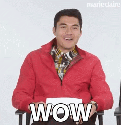 Man in Red Jacket Holding Paper Saying Wow