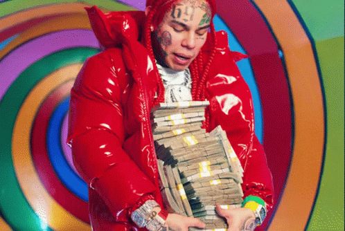 Man in Red Jacket Holding Stack of Money
