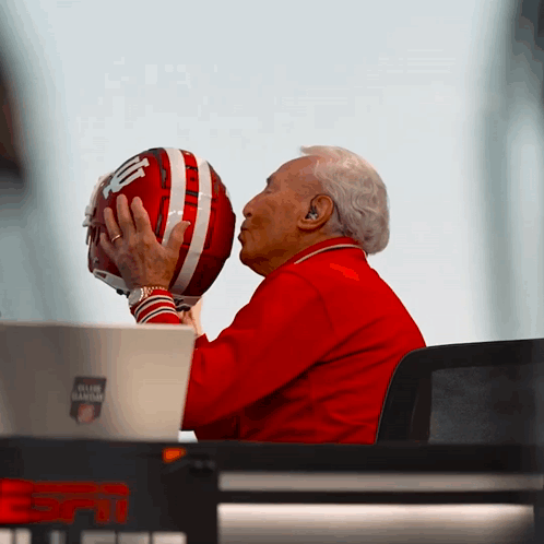 Man in Red Jacket Kissing Football Helmet