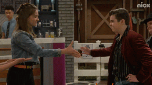 Man In Red Jacket Shaking Hands With Girl In Denim GIF