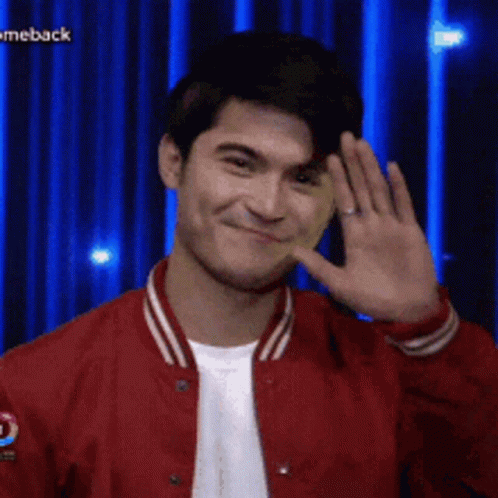 Man In Red Jacket Smiling And Waving GIF