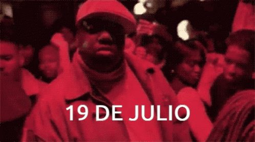 Man in Red Jacket Standing in Front of Crowd