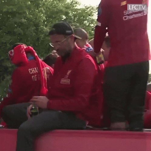 Man in Red Jacket With Champions