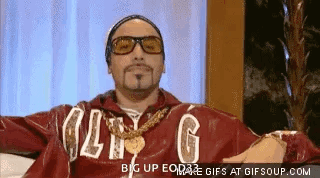 Man in Red Jacket With Letter G Arms Outstretched on Couch