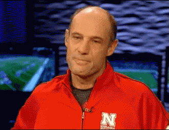 Man in Red Jacket With Letter N