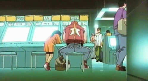 Man in Red Jacket With Star at Arcade Machine