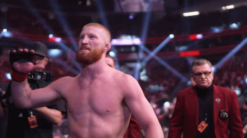 Man in Red Jacket With UFC Lanyard
