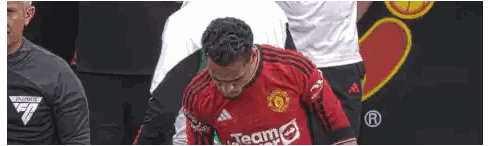 Man in Red Jersey Kneeling