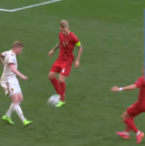 Man In Red Jersey Number 4 Kicks Soccer Ball GIF