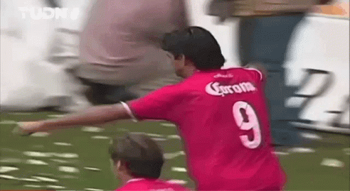 Man in Red Jersey Playing Soccer