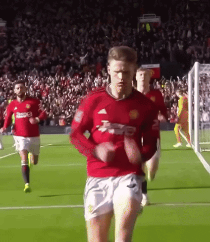 Man in Red Jersey Running Soccer Field