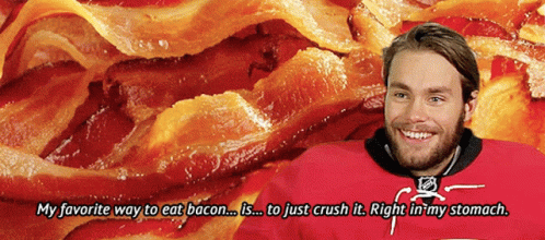 Man in Red Jersey Smiling at Pile of Bacon