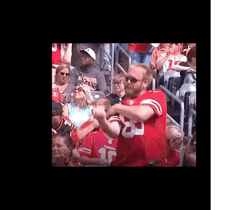 Man in Red Jersey Standing in Crowd