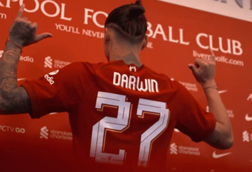 Man In Red Jersey With Darwin On Back GIF