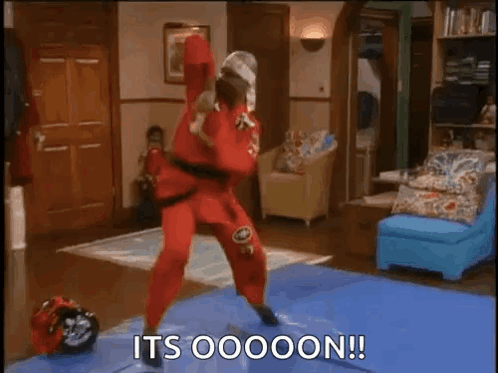 Man in Red Karate Outfit on Blue Mat