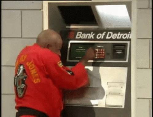 Man in Red Karate Uniform Using Bank of Detroit ATM