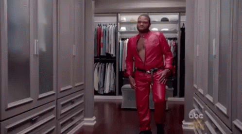 Man in Red Leather Suit Walking Down Closet