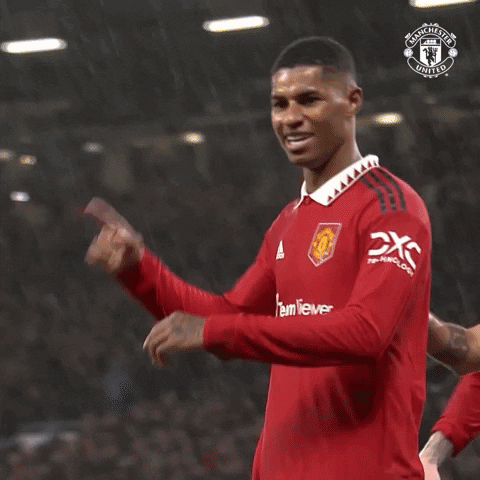 Man In Red Manchester United Jersey Holding Finger To Head GIF