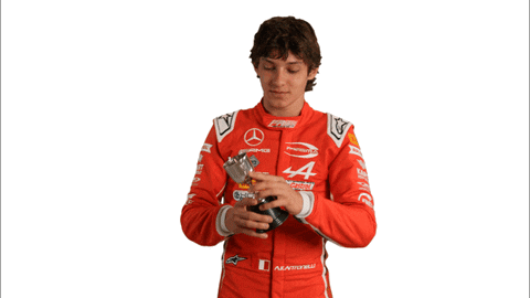 Man in Red Mercedes Racing Suit Holding Key