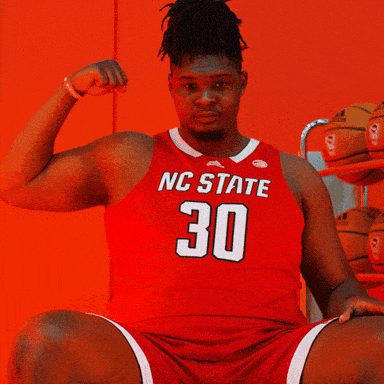 Man in Red NC State Jersey Flexing Arm