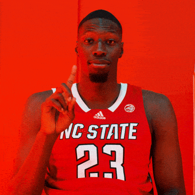 Man in Red NC State Jersey Pointing Up