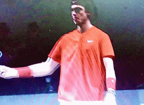 Man in Red Nike Shirt Holding Tennis Racket