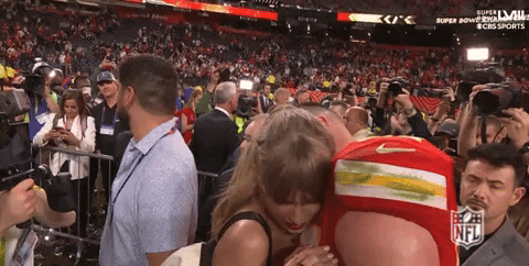 Man in Red Nike Shirt Hugging Woman at Super Bowl