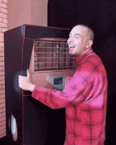 Man in Red Plaid Shirt Laughing Holding Machine