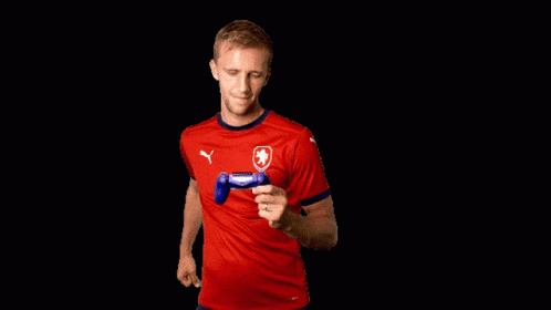 Man in Red Puma Shirt Holding Controller