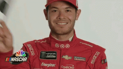 Man in Red Racing Suit and Hat Smiling