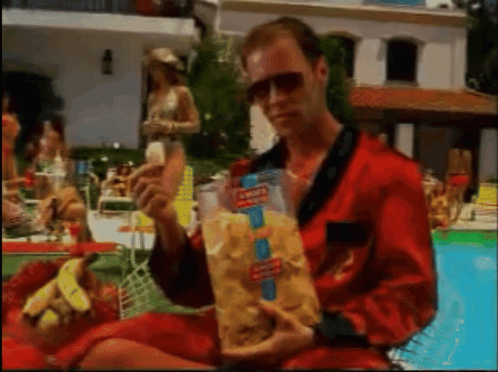 Man In Red Robe Holding Bag Of Doritos Chips GIF